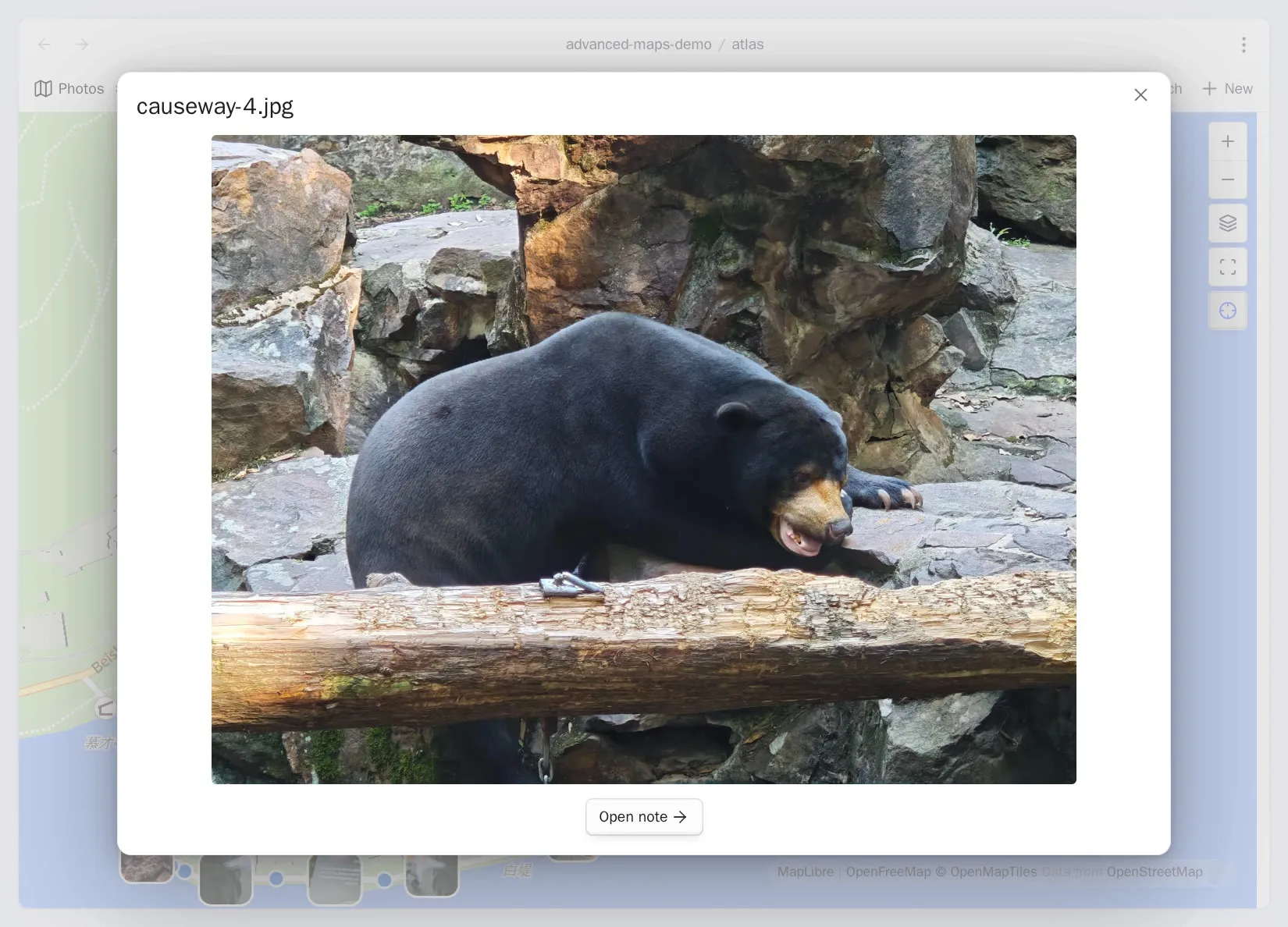 A geotagged photo opened from its marker, with the image, filename, and an Open note action in a modal over the map